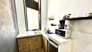 A compact kitchen with a sink, a microwave, and a coffee maker. - VIP 2 Bedrooms Apt at Historic Center TV Roof (Oaxaca de Juárez)