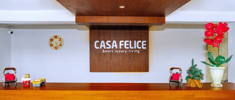 A reception desk with a wooden sign that reads "CASA FELICE Smart luxury living."