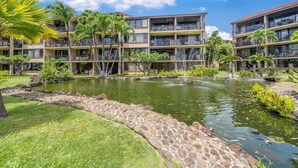 A hotel with multiple floors, outdoor pools, and lush greenery. - Rare LUX Oceanfront Views, Pool, Paradise - Papakea L402 (Lahaina)