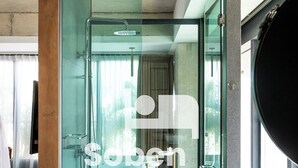 A modern bathroom with a glass-enclosed shower, a large mirror, and a bathtub. - Royal Palace Suites Phnom Penh by Soben (Phnom Penh)