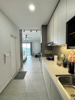 Full-size fridge, microwave, stovetop, cookware/dishes/utensils