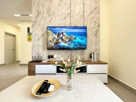 Deluxe Apartment | Living room | 50-cm LCD TV with cable channels, Netflix, streaming services