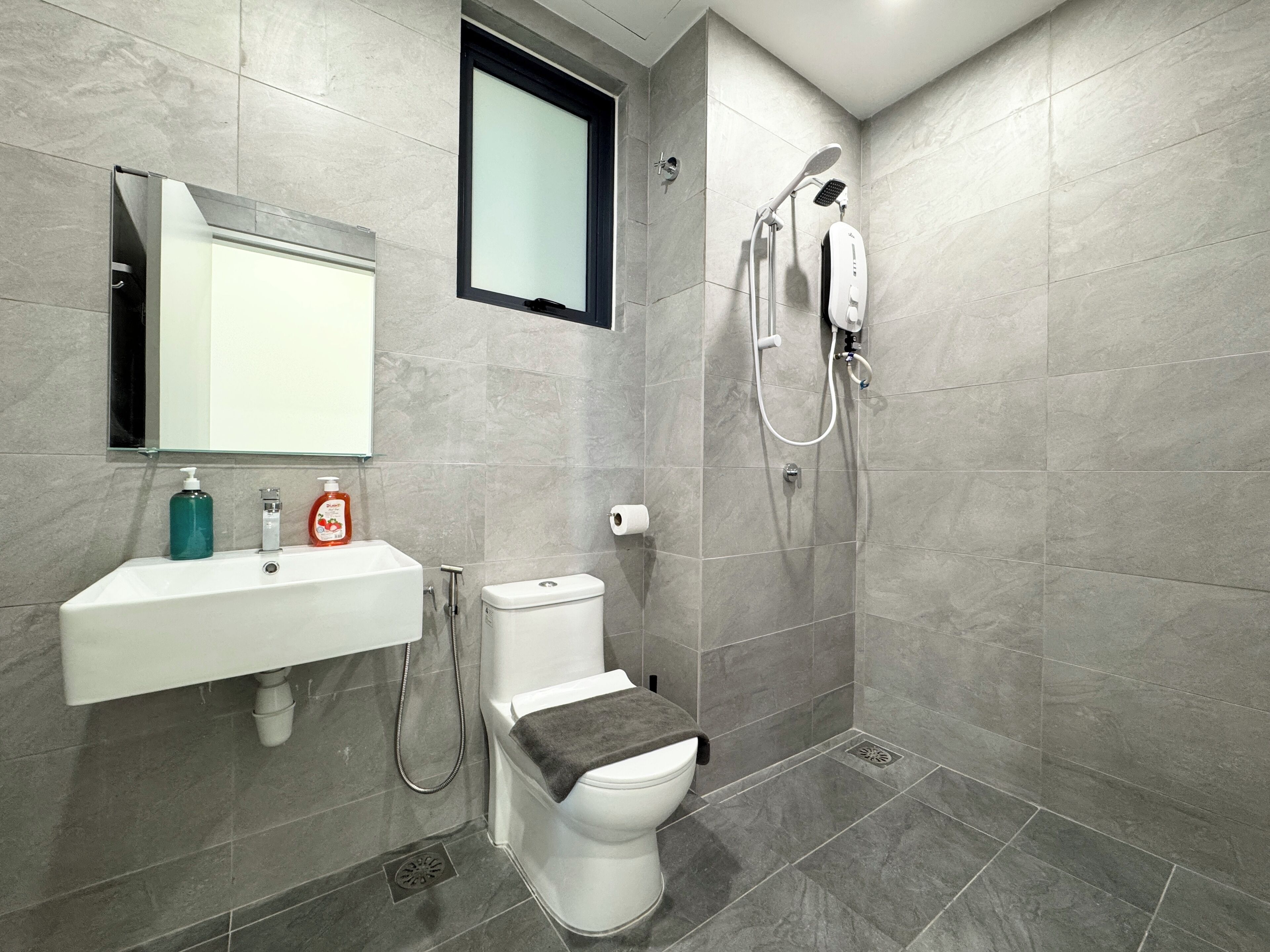 Une salle de bain moderne équipée de toilettes, d’un bidet et d’une douche.