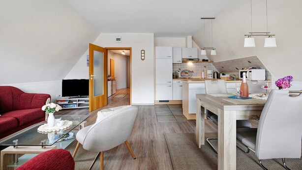 Eine moderne Wohnung mit Wohnzimmer, Essbereich und Küche.