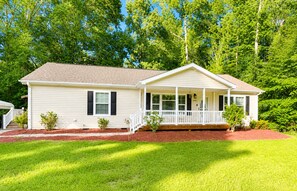 A single-story house with a front porch, a small garden, and a mailbox. - Beautiful, Cozy home in Concord providing a spacious & tranquil retreat (Concord)