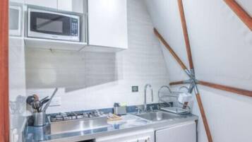 Fridge, microwave, coffee/tea maker, cookware/dishes/utensils