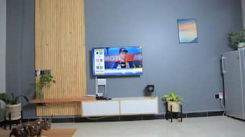 Deluxe Apartment, Non Smoking, Hill View | Living area | Flat-screen TV