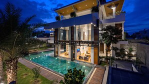 A modern two-story house with a swimming pool, large windows, and outdoor lighting. - Glamorous getaway VILLA in Bien Hoa (Bien Hoa)