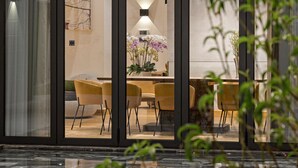 A modern interior with a glass-enclosed dining area, a pool, and a view of the outdoors. - Glamorous getaway VILLA in Bien Hoa (Bien Hoa)
