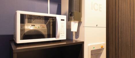 A microwave and an ice dispenser in a hotel room.