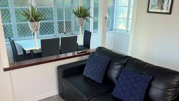 Premium Apartment, 1 Bedroom | Living area | 50-inch Smart TV with digital channels, Netflix, streaming services