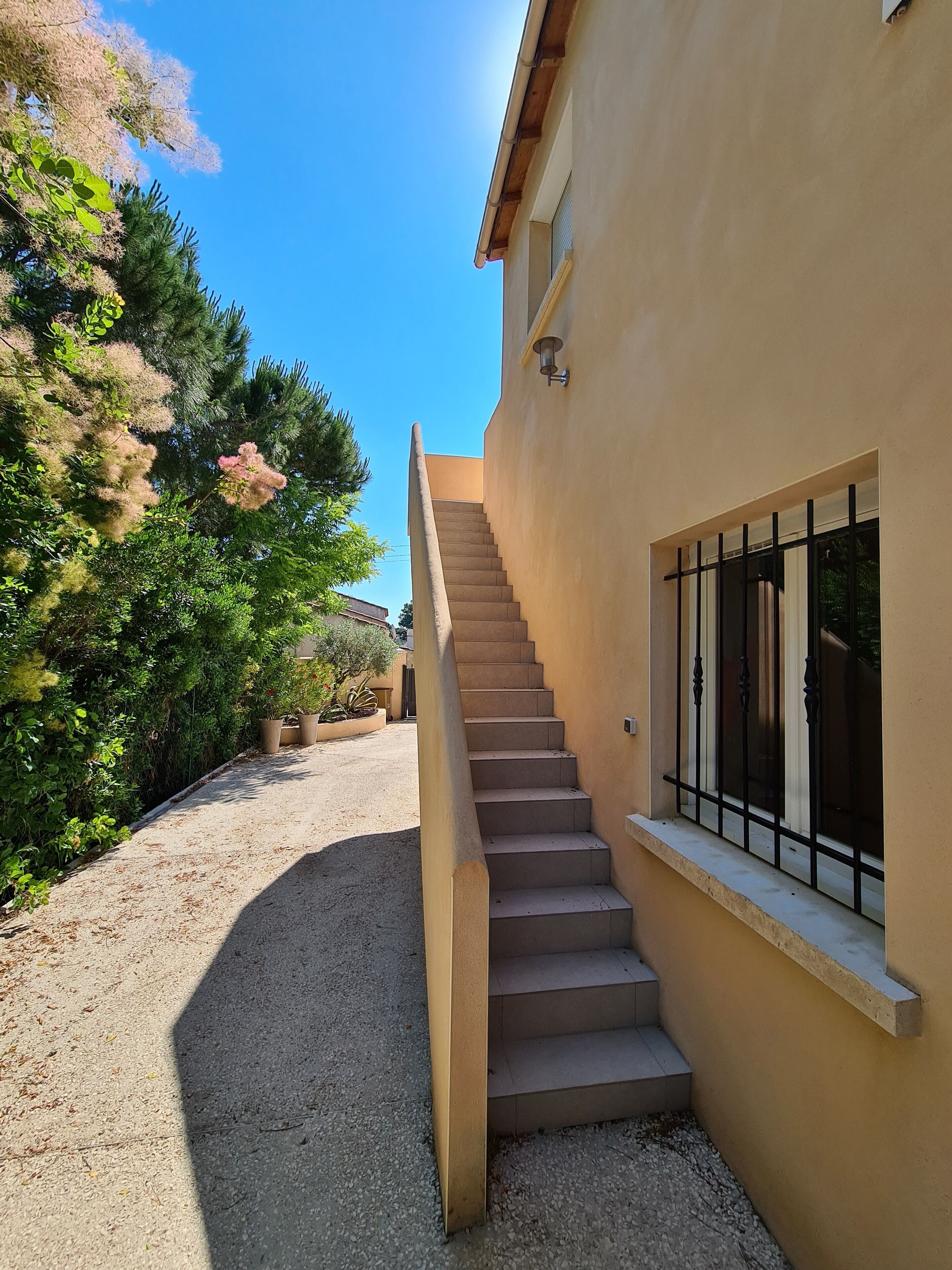 A staircase leading to a building with a window and a door.