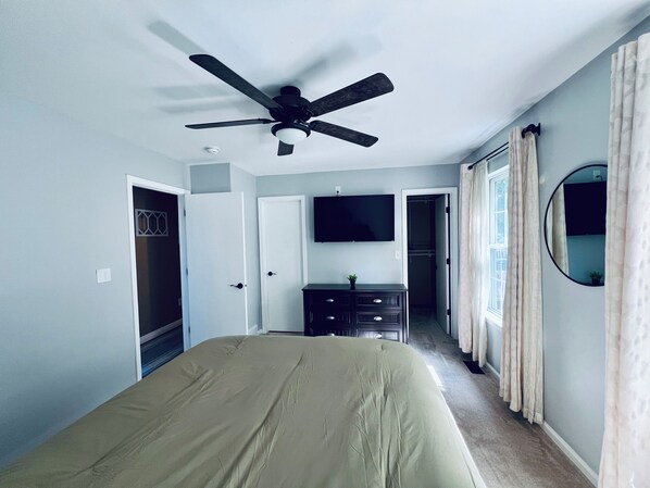 A bedroom with a bed, a ceiling fan, a TV, a dresser, and a closet. - NEW Spacious Home Minutes From Oneida Lake & Fall Festivities! (Brewerton)