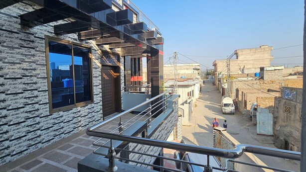 A modern building with a brick facade and large windows. - Mirpur 3-bed House Sleeps 6 (Mirpur)