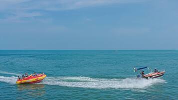 A water sport activity with a boat and a tube.