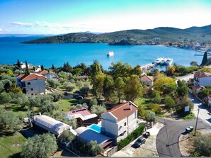 Un pueblo costero con casas, un puerto deportivo y un barco amarrado.