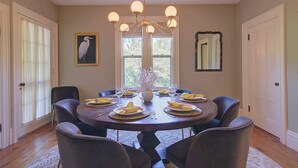 A dining room with a round table set for six, surrounded by chairs. - Short Drive to Gray's Beach! (Yarmouth)