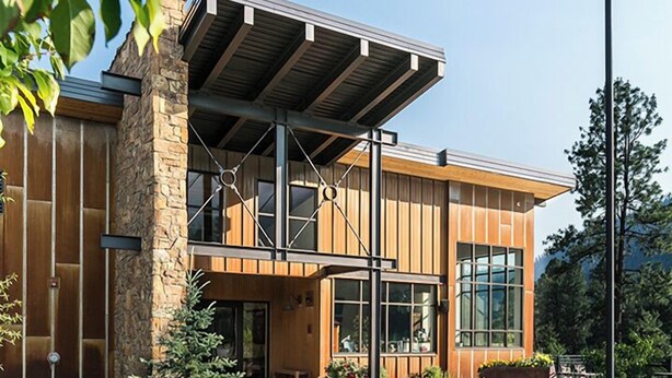 A modern building with a stone facade, large windows, and a covered entrance area. - Cliffside Suite | AC, Pool, Hot Tub, Golf & Ski (Durango)