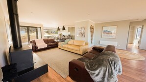 A modern living room with a sofa set, a coffee table, and a fireplace. - The Staggerinn - Dinner Plain (Dinner Plain)