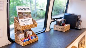 A welcome sign and a wicker basket with snacks on a counter. - Creekside Fern in Pisgah Forest (Pisgah Forest)