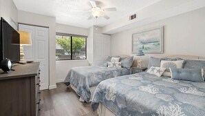 A bedroom with two beds, a ceiling fan, a TV, and a window with a view. - Close to the Boardwalk, Jolly Roger Amusement Park With a Pool! (Ocean City)