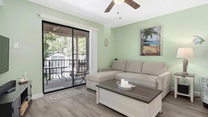 A living room with a sectional sofa, a coffee table, a TV, and a ceiling fan. - Close to the Boardwalk, Jolly Roger Amusement Park With a Pool! (Ocean City)