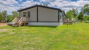A single-story mobile home with a front deck and a small staircase. - Kadoka Home ~ 22 Mi to Badlands National Park! (Kadoka)