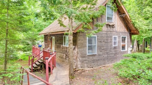 A rustic cabin with a wooden exterior, a porch, and a staircase leading to the entrance. - Denmark Waterfront Cabin w/ Dock & Charcoal Grill! (Denmark)