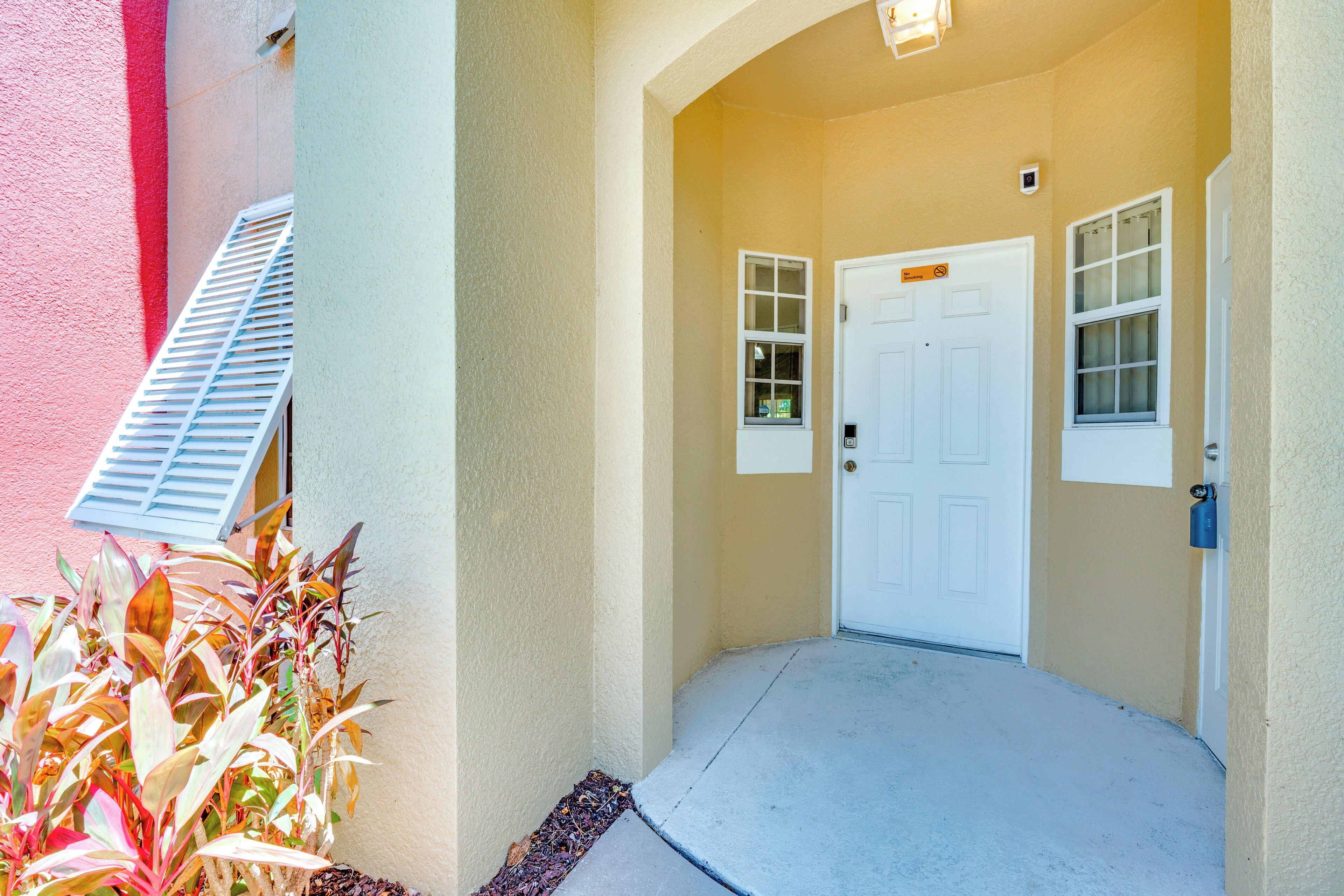 A building entrance with a white door, a small window, and a mailbox.