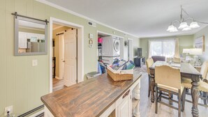A kitchen with a wooden countertop, a dining area with a table and chairs, and a laundry area with a washing machine. - 1 Mi to Beach, Pool Access: Hilton Head Island Gem (Hilton Head Island)
