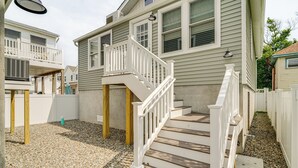 A residential building with a wooden staircase and a balcony.