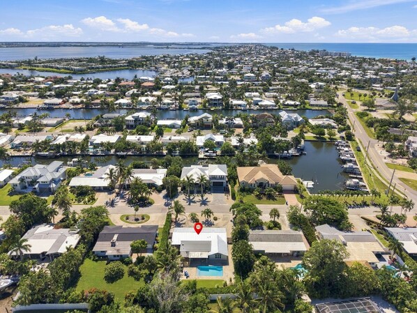 A residential area with houses, a marina, and a large body of water.