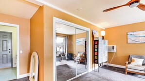 A hotel room with a large mirror, a ceiling fan, a sofa, and a carpeted floor. - Yosemite Wellbeing Retreat on 5 Acres w/ Mtn Views (Ahwahnee)