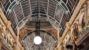 A spacious, ornate corridor with a high, glass-domed ceiling and marble floors, featuring a central walkway and ornate columns. - Leeds City Escape - Stylish Apartment (Leeds)