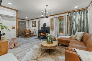 House, Multiple Beds, Hot Tub, Mountain View (Honey Bee Hideout) | Living area | 42-inch flat-screen TV with digital channels, fireplace - Stylish Cabin w/ Hot Tub, Games & More! (Sevierville)