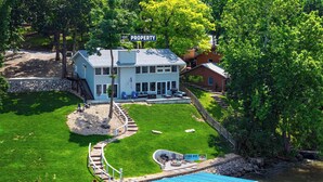 A large two-story house with a covered patio and a fire pit area. - For the View Lakeside Launchpad! Great Location (Gravois Mills)