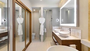 A modern bathroom with a large mirror, two sinks, a bathtub, and a shower area. - Beach front property, excellent service,  and food.Unforgettable experience.  (San José del Cabo)