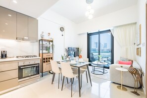 Fridge, microwave, oven, stovetop - Charming 1BR Apartment in Azizi Gardens Nad Al Sheba by Deluxe Holiday Homes (Dubai)
