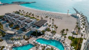 A resort with a pool, beach, and ocean view. - Seafront 4BR Apartment with Assistant Room in The Address Fujairah Residences Block B, Fujairah (Fujairah)