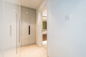A modern, minimalist hallway with a glass door leading to a bathroom. - Seafront 4BR Apartment with Assistant Room in The Address Fujairah Residences Block B, Fujairah (Fujairah)