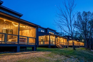 A modern wooden cabin with large windows and a deck. - Still Waters on Watauga River (Johnson City)