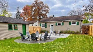 A two-story building with a patio area featuring outdoor seating. - Remodeled Home 1 Mile From Notre Dame 1150 (South Bend)