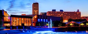 A cityscape with modern buildings, a flowing water feature, and a well-lit plaza. - 3 Blocks to Notre Dame 2 Bedroom 1 Bath Home 815 (South Bend)