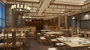 A spacious dining area with multiple tables and chairs, wooden paneling, and a chandelier. - Greentree Eastern Hotel (Zhongshan West Road, Xiuzhou District, Jiaxing) (Jiaxing)