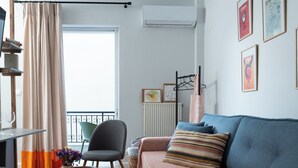 A modern living room with a sofa, a chair, a coffee table, and a TV. - Modern & Sunny apartment with Garden View in the heart of the city center NYX 1 (Tripoli)