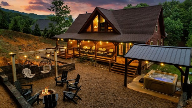 A log cabin with a cozy outdoor seating area, a hot tub, and a fire pit. - Newly Renovated! Fishing, Full Game Rm, Hot Tub! (Sevierville)