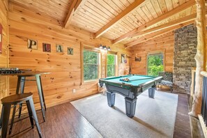 A wooden room with a pool table, a bar stool, and a zebra-patterned chair. - Pigeon Forge I Hot tub I Theatre I Walk to Parkway (Pigeon Forge)