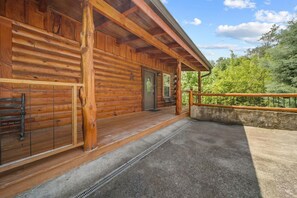 A log cabin with a porch, a door, and a window. - Pigeon Forge I Hot tub I Theatre I Walk to Parkway (Pigeon Forge)