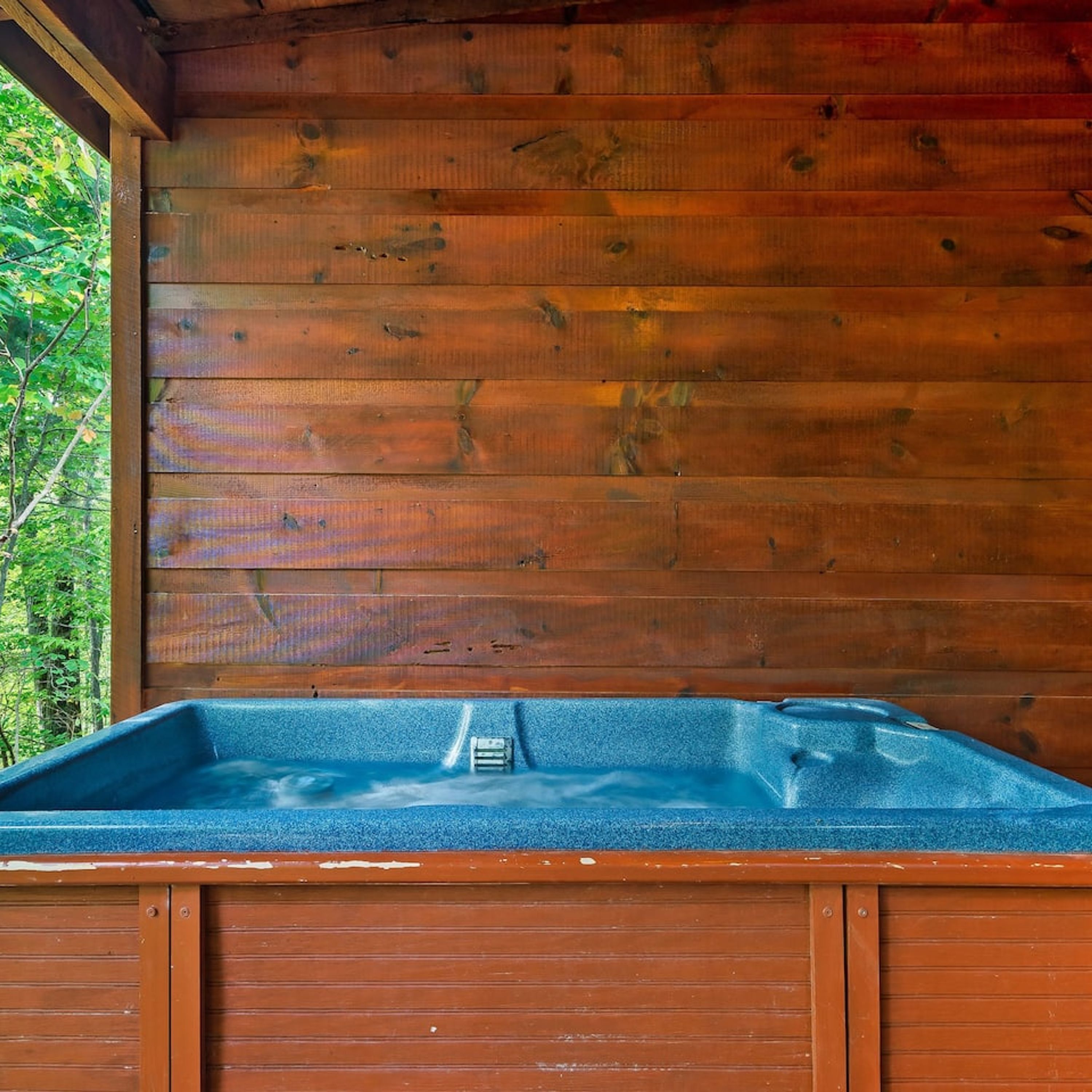 A wooden cabin with a hot tub.