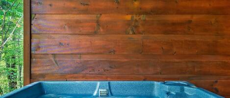 A wooden cabin with a hot tub.